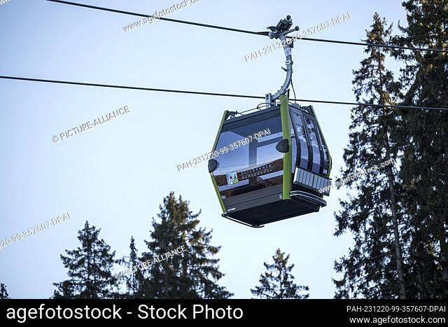 PRODUCTION - 18 December 2023, Bavaria, Bischofsgrün: A gondola of the new 10-passenger single-cable gondola lift travels from the valley station north to the...