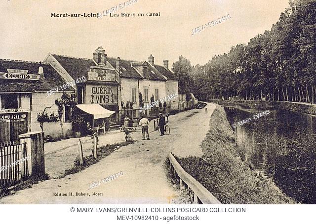 Moret-sur-Loing, a commune in the Seine-et-Marne department in the Ile-de-France region in north-central France - Houses and a Wine Shop on the Canal