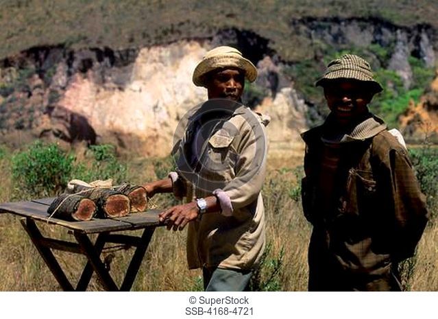 Madagascar, near Ambatolampy, local men selling sweet cake