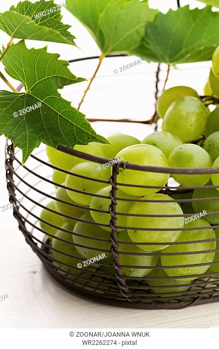 Bunch of white grapes in basket