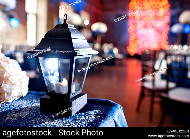Lights and lanterns in the night. Bokeh Wedding Banquet. The chairs and round table for guests