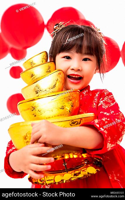 Lovely little girl holding the gold ingot
