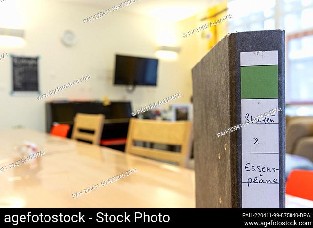 PRODUCTION - 07 April 2022, Bavaria, Nuremberg: A folder with meal plans for patients stands on a table in the day room of the psychosomatic ward for children...