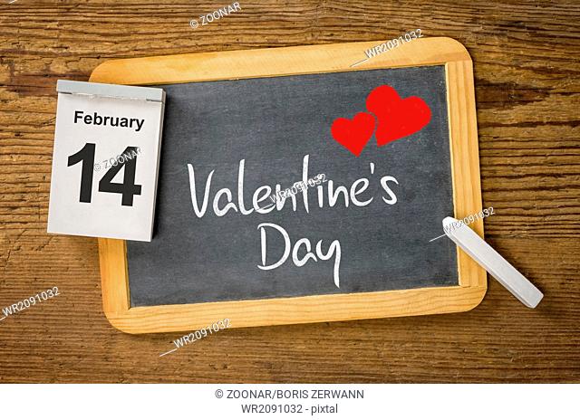 Calendar and blackboard showing February 14, Valentine's day
