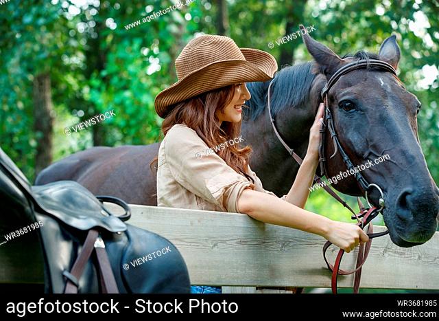 Outdoor fashionable young women and horses
