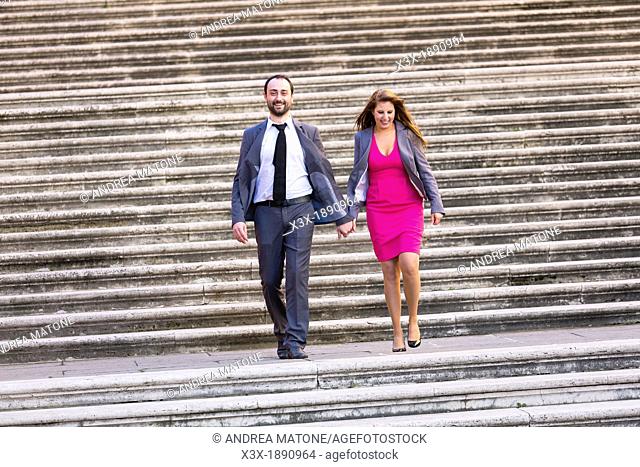 Engagement couple walking on stairs in Rome Italy
