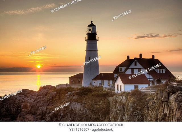 The first rays of sun after sunrise reach the Portland Head Light, built in 1791, which protects mariners entering Casco Bay