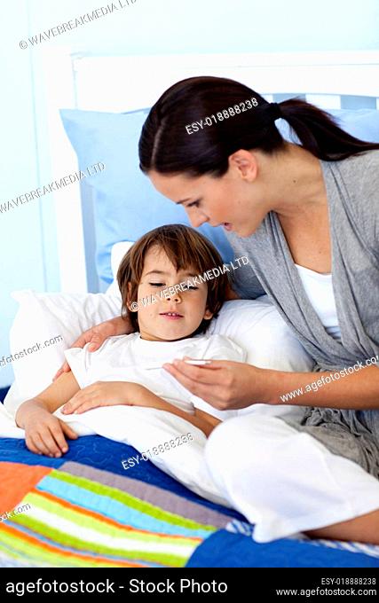 Mother taking her son's temperature