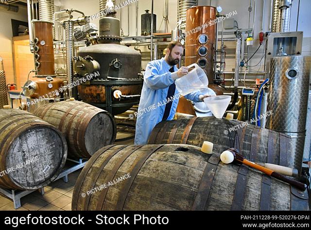 20 December 2021, Saxony-Anhalt, Zeitz: At Zeitzer Whisky Manufaktur, owner Daniel Rost works in the distillery of his small company