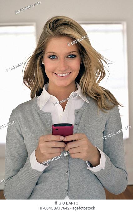 Young woman portrait holding cell phone