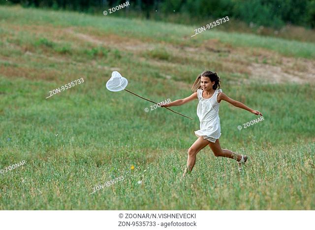 girl running with butterfly net over a butterfly