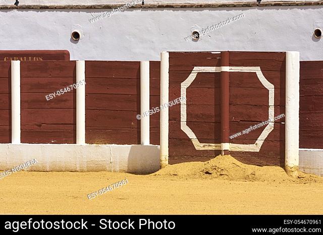 barrier in a bullring with sand