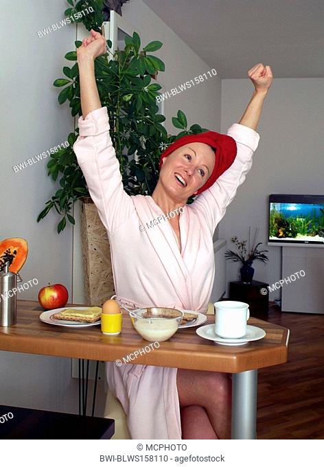 young woman at substantial breakfast, stretching