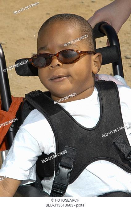 Really cool little guy with multiple disabilities on an outing with family and friends
