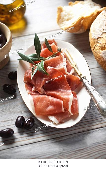 Serrano ham with bread and olives