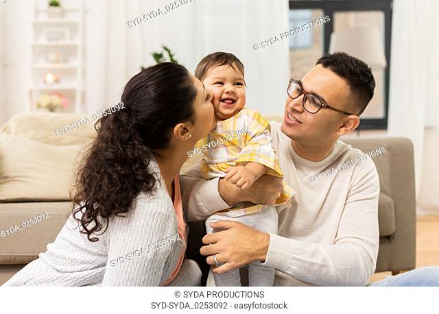 happy family with baby daughter at home