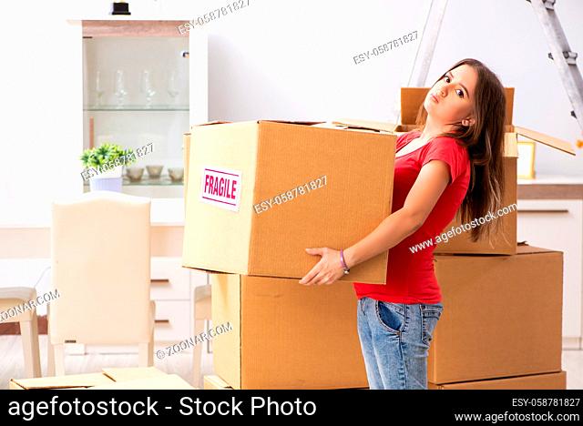 Young beautiful woman moving to new flat