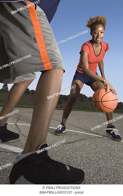 African woman playing basketball