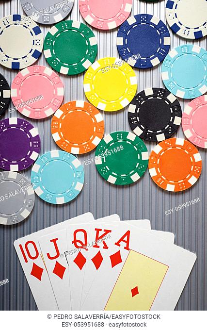 Cards and casino chips on a metal surface