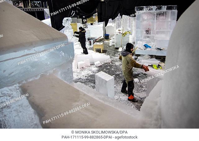 Artists work on an ice sclptures before the opening of the ice and snow sculpture exhibition with the topic 'Winterwelten' (lit