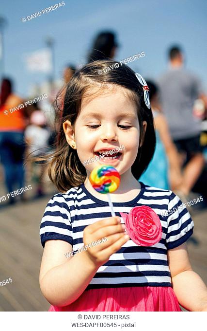 USA, New York, Coney Island, happy little girl with lollipop