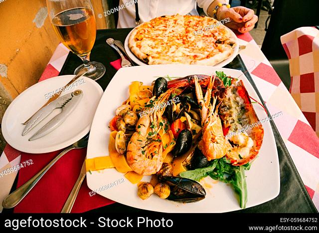 Seafood pasta, pizza and beer in Italy