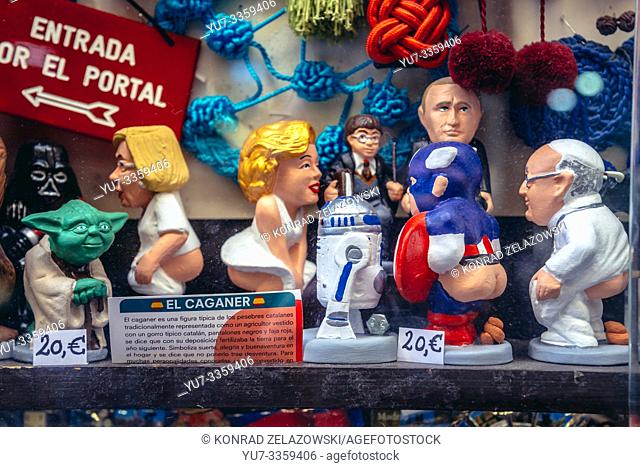 Modern caricature of Catalan traditional figurines depicted in the act of defecation called Caganer for sale in Madrid, Spain