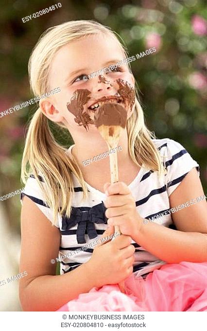 Young Girl Covered In Chocolate Licking Spoon