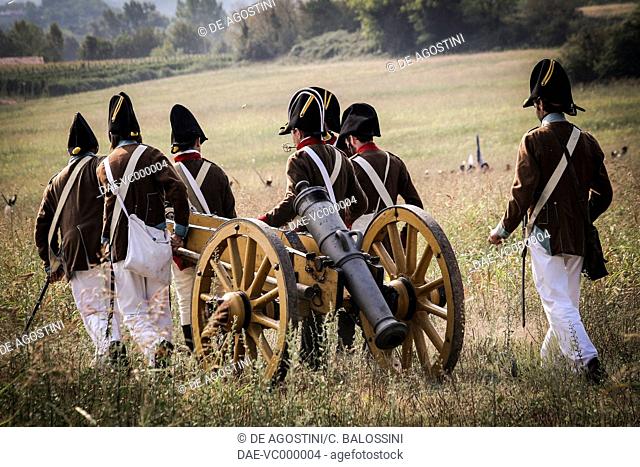 Artillerymen of the Austrian imperial army moving a piece of artillery. Napoleonic wars, 19th century. Historical reenactment