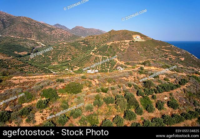 Aerial view from drone on cretan landscapes. Olive groves on the hils and mountain slopes. Rethymno prefecture near Almirida village. Crete, Greece