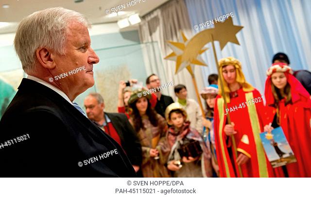 Premier of Bavaria, Horst Seehofer (CSU), receives five groups of carolers from the diocese Passau at the state chancellery in Munich, Germany, 30 December 2013
