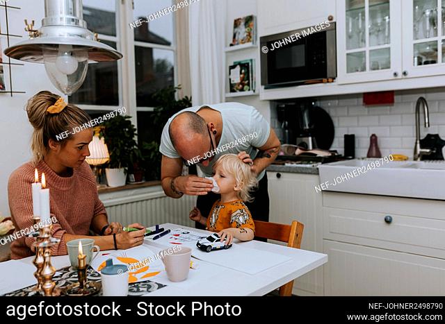 Parents with toddler in kitchen