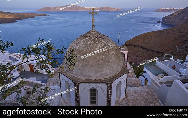 Early morning, wide angle, dome of a church, houses, cliffs, caldera and Thirasia island in the background, Santorini Island, Cyclades, Greece, Europe