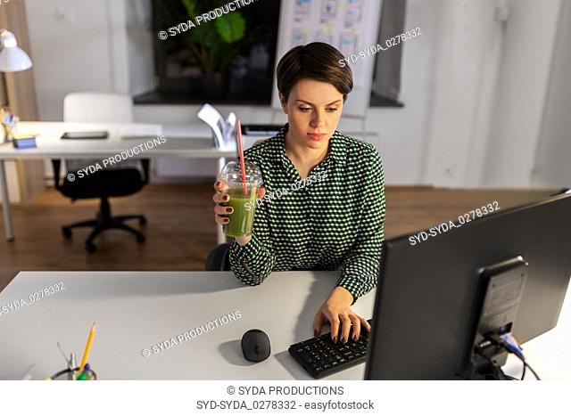 businesswoman working on computer at night office