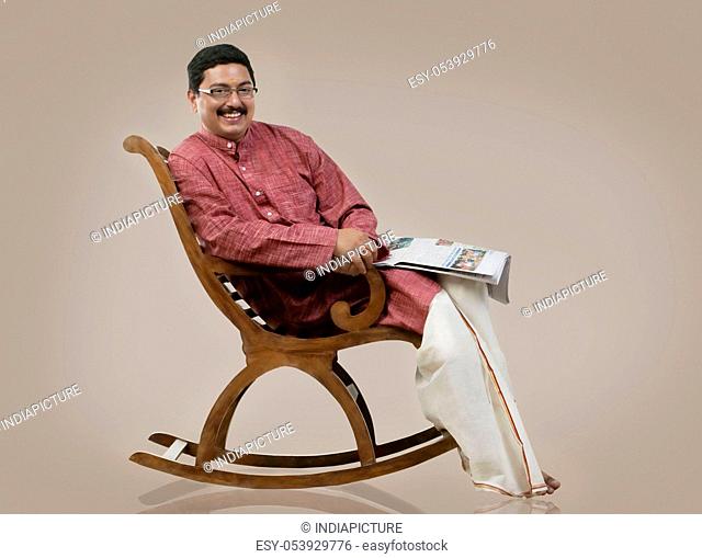 South Indian man sitting on a chair