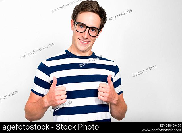 Studio shot of young handsome man against white background