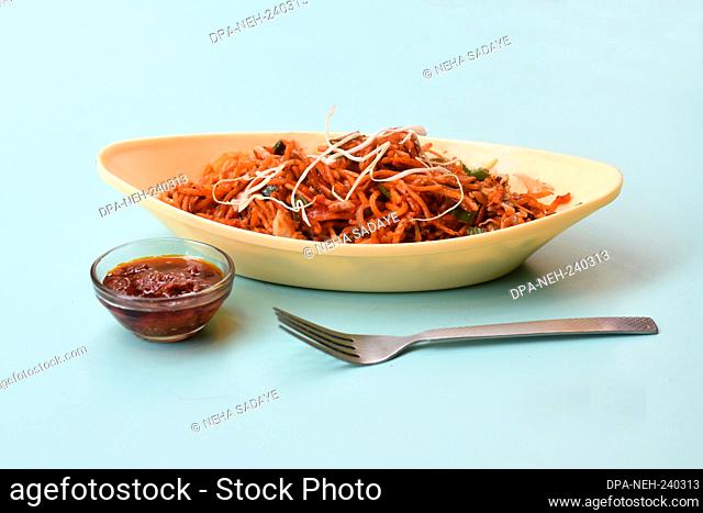 Schezwan Noodles or Manchurian Hakka or vegetable Hakka Noodles or chow mein is a popular indochinese food served in a bowl