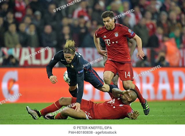 Munich's Arturo Vidal (bottom) and Xabi Alonso (R) in action against Madrid's Fernando Torres during the UEFA Champions League semi final second leg soccer...