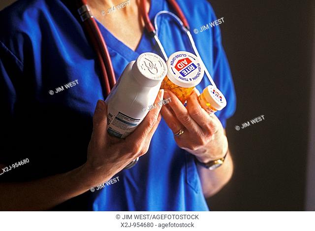 Detroit, Michigan - Registered nurse Susan Newell holds the anti-HIV medicines she must take after an accidental needle stick  Newell works at a hospice with...