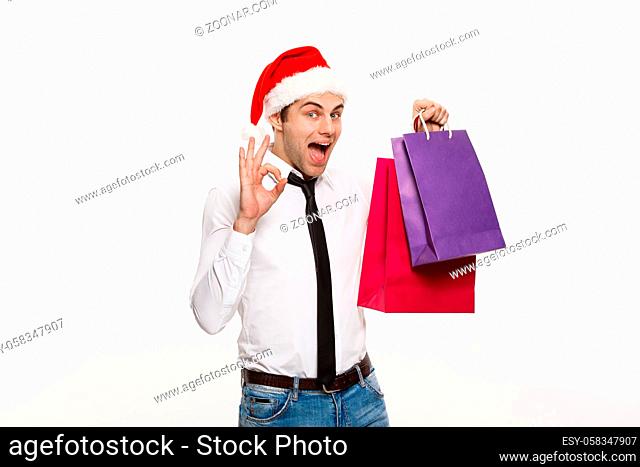 Christmas Concept - Handsome Business man celebrate merry christmas and happy new year wear santa hat with Santa red big bag