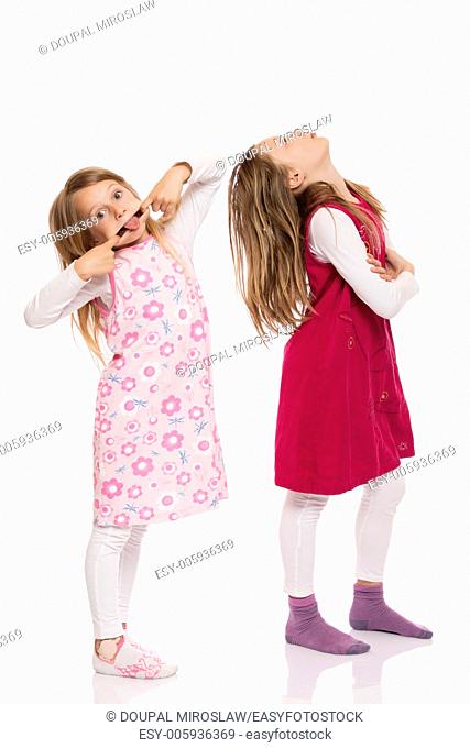 Two funny children with long hair making faces. Isolated on white background