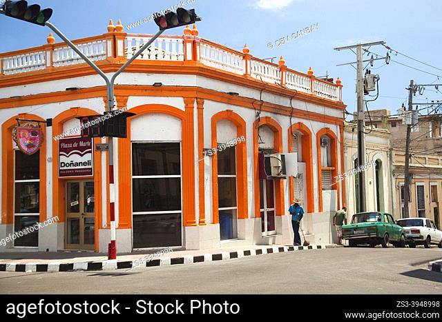 Local people and Russian cars in front of colonial buildings at the historic center, Santiago De Cuba, West Indies, Central America