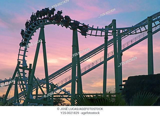 Isla Magica (Magic Island) Theme Park, The Jaguar at sunset - roller coaster (and people upside), Seville, Region of Andalusia, Spain, Europe