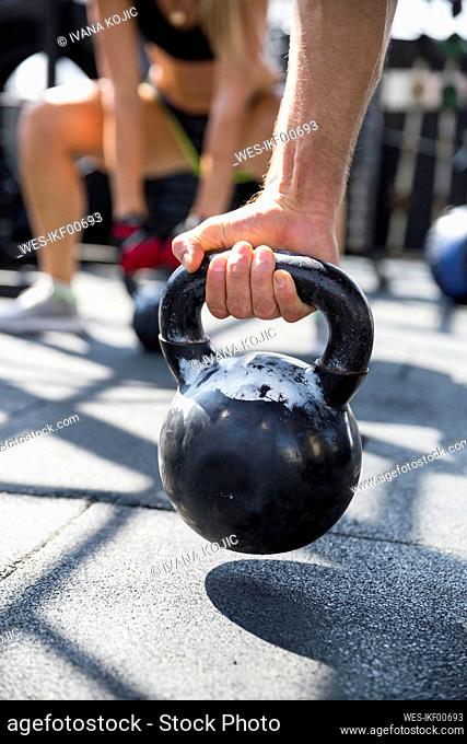 Man exercising with kettlebell at rooftop gym
