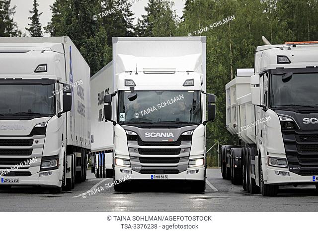 Turku, Finland. August 23, 2019. Scania G500 semi trailer parks between two white Scania R trucks. Scania in Finland 70 years tour