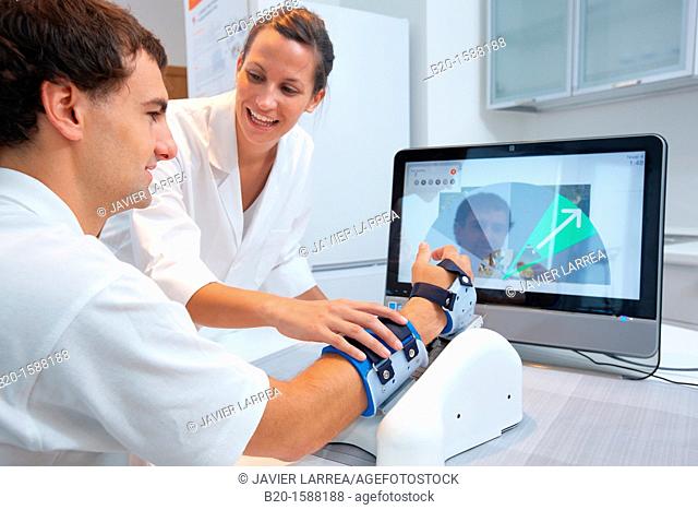Investigator and patient with assistive robot for upper limb rehabilitation at home  This device is particularly suitable for patients who have suffered a...