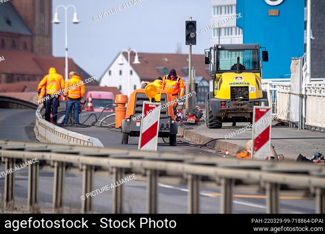 29 March 2022, Mecklenburg-Western Pomerania, Wolgast: Workers work on the Peene Bridge a Wolgast.Anyone who wants to get to or from Germany's second-largest...