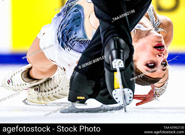 RUSSIA, CHELYABINSK - DECEMBER 21, 2023: Pair skaters Alyona Kostornaya and Georgy Kunitsa perform a death spiral during a pairs' short programme event as part...