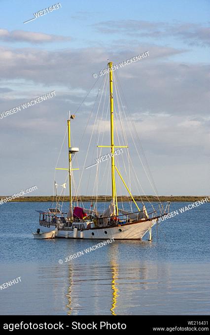 Sailboat moored at the harbor in front of Olhao, Algarve, Portugal, Europe