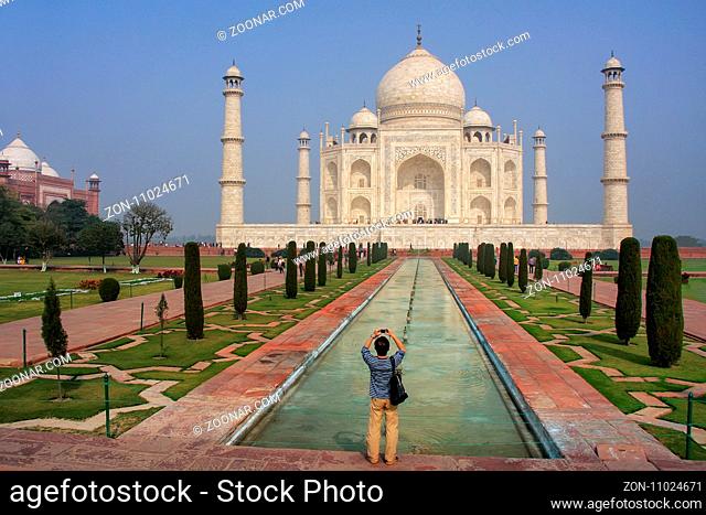 Tourist photographing Taj Mahal in Agra, Uttar Pradesh, India. It was build in 1632 by Emperor Shah Jahan as a memorial for his second wife Mumtaz Mahal